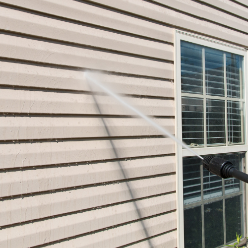 Professional pressure washing services cleaning house siding in Vancouver, WA by Top Notch Painting & Construction LLC.